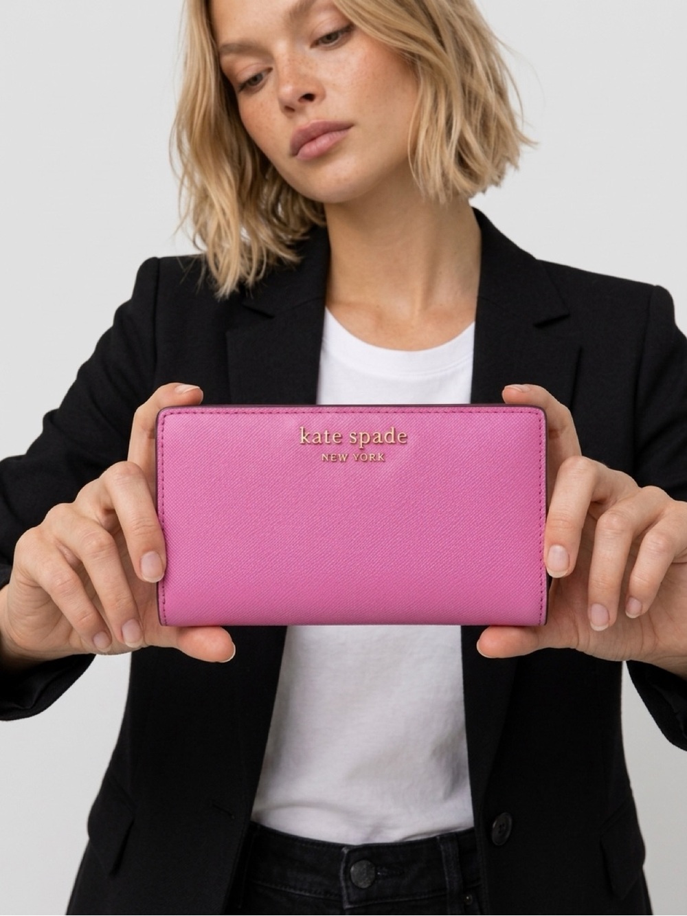 Kate Spade Pink color bi-fold wallet.
